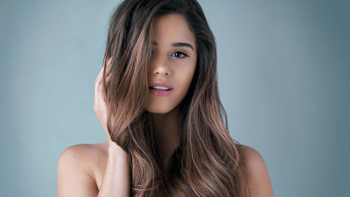 Woman with long, glossy brunette hair – hero image for Cruz Hairworks homepage, reflecting expert styling and premium salon care in Whitley Bay.