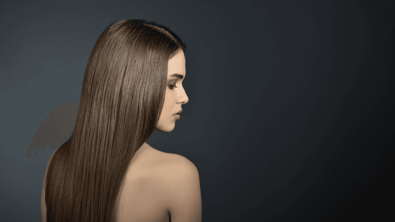 Woman with long, smooth, professionally styled hair viewed from behind—showcasing seamless hair extensions or sleek finish at Cruz Hairworks in Whitley Bay.
