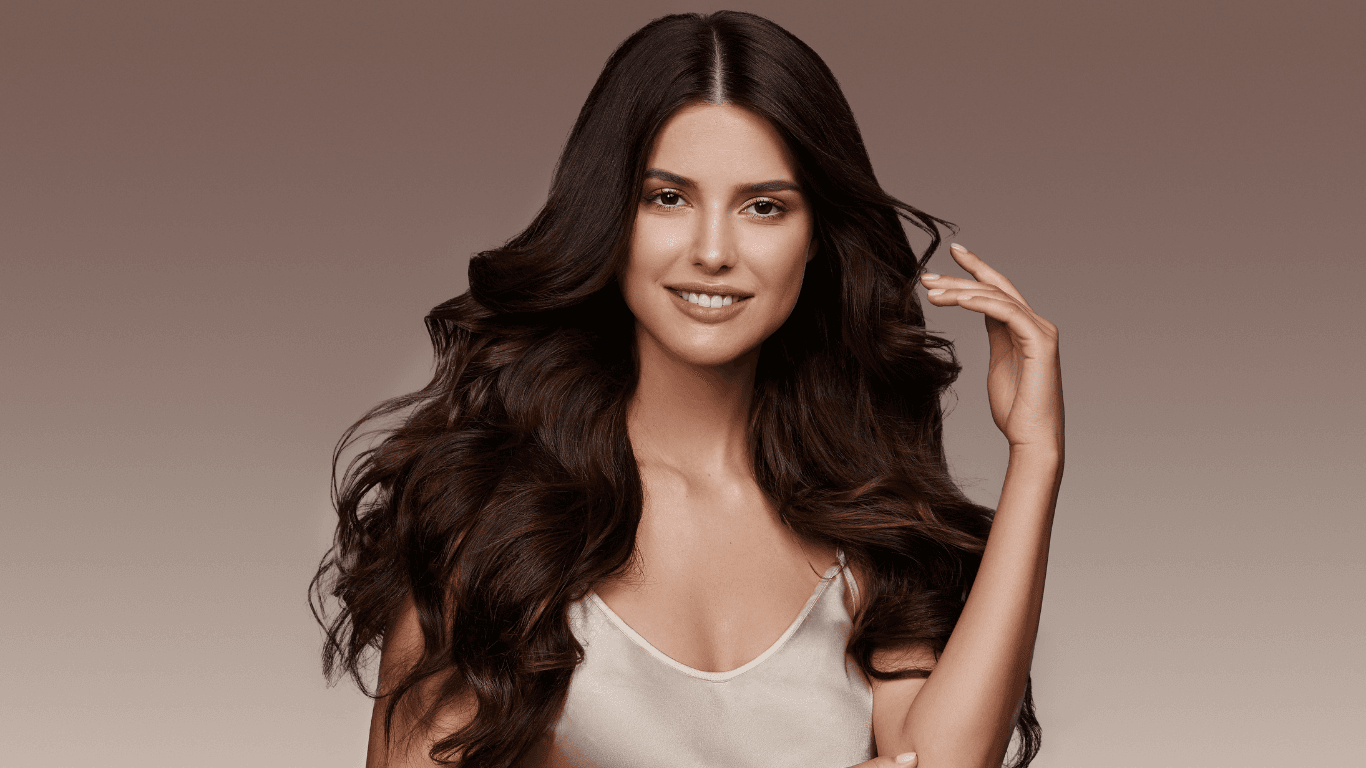 Woman with long, voluminous brunette hair styled with professional hair extensions – service available at Cruz Hairworks in Whitley Bay.