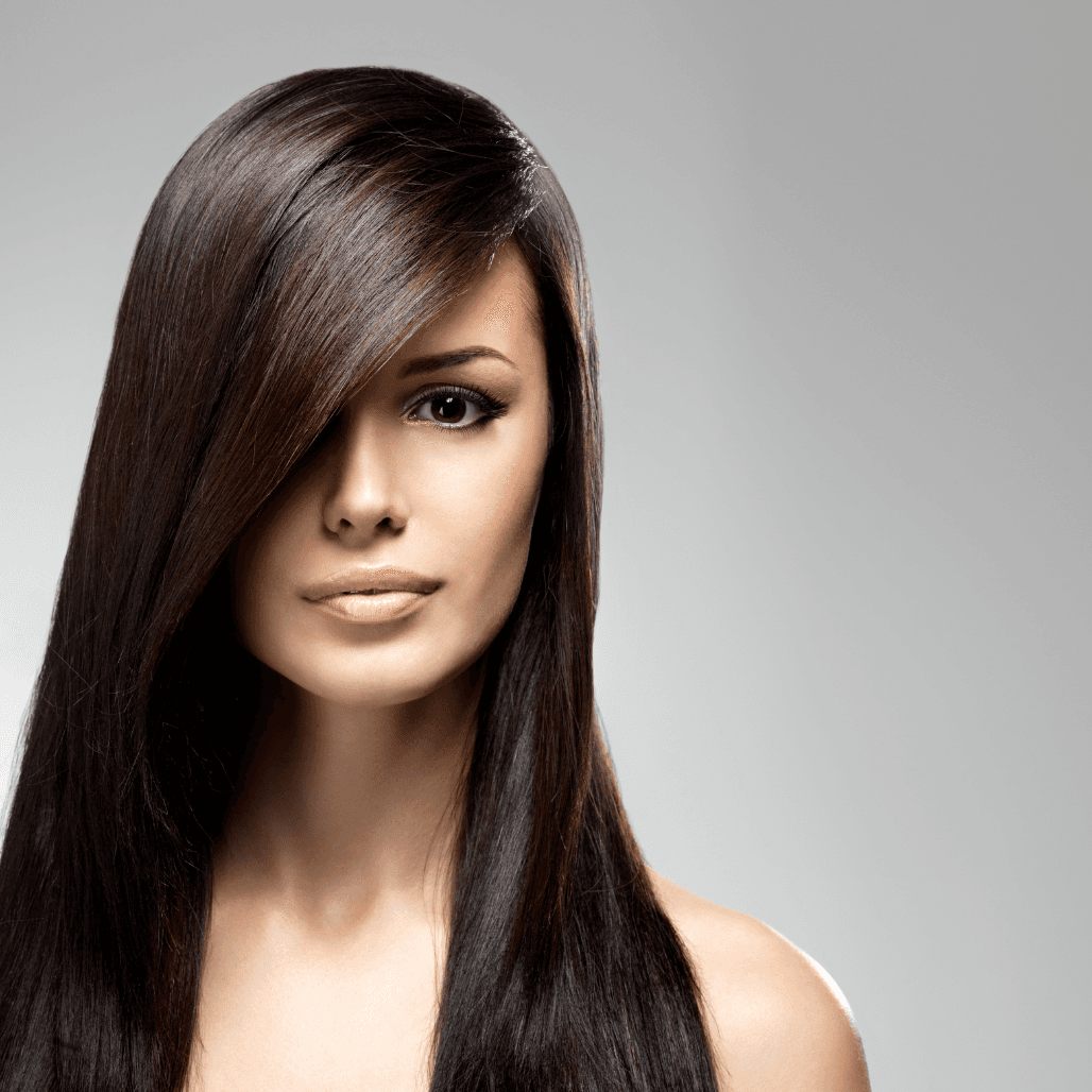 Woman with sleek, glossy dark hair – showcasing the results of professional moisturising and conditioning treatments at Cruz Hairworks in Whitley Bay.