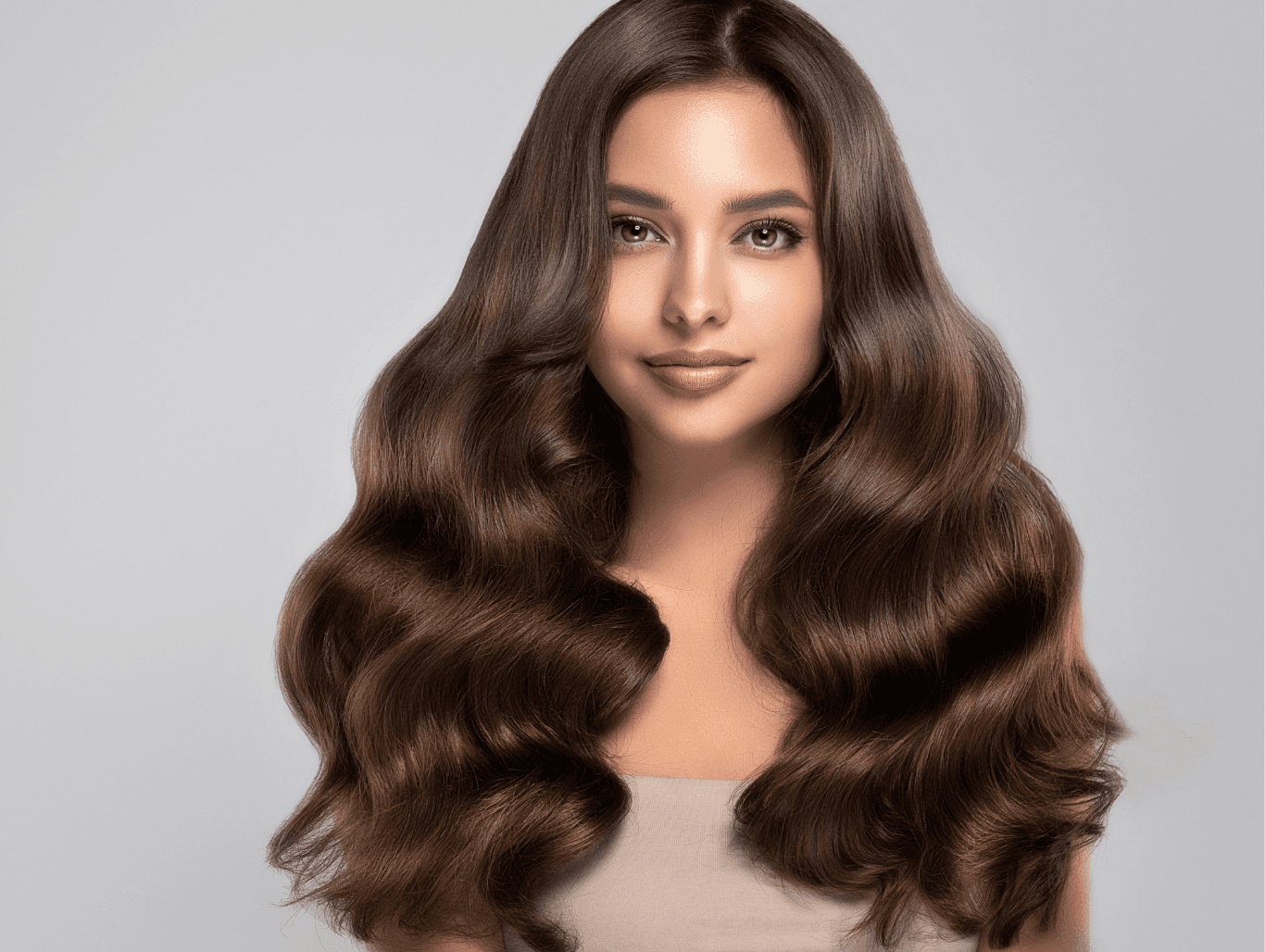 Woman with soft, glossy brunette waves finished with a rich semi-permanent colour at Cruz Hairworks